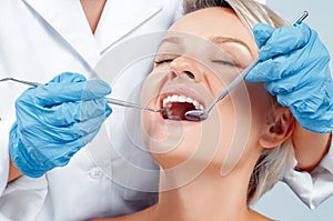 Dentist examining a patient`s teeth in the dentis