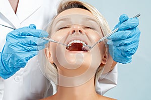 Dentist examining a patient`s teeth in the dentis