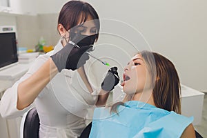 Dentist examining a patient`s teeth in the dentist.