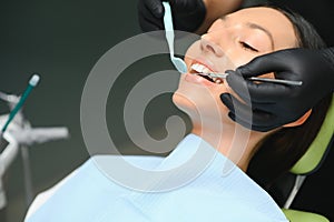 Dentist examining a patient& x27;s teeth in the dentist