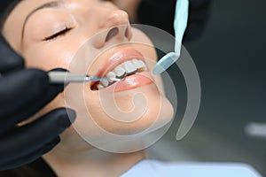 Dentist examining a patient& x27;s teeth in the dentist