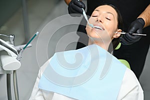 Dentist examining a patient's teeth in the dentist