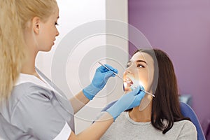 Dentist examining a patient`s teeth in the dentist office