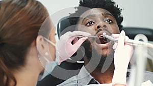 Dentist examining a patient`s teeth in the dentist office