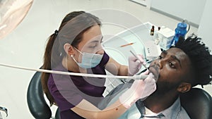 Dentist examining a patient`s teeth in the dentist office