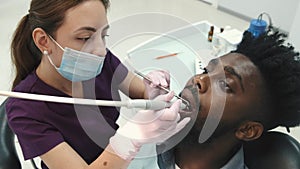 Dentist examining a patient`s teeth in the dentist office