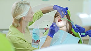Dentist examining patient teeth with dental tools. Doctor and patient