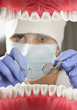Dentist examining patient teeth, Inside mouth view. Soft focus