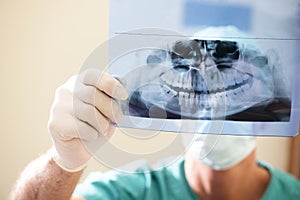 Dentist Examining X-Ray