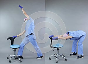 Dentist  exercising at the mobile chair.Plank position.