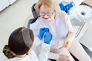 Dentist explain dental bleaching to patient photo