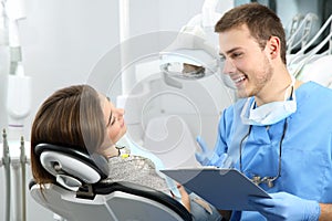 Dentist explaining dental treatment procedure to a patient