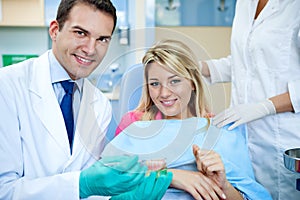 Dentist explaining a female patient denture work photo