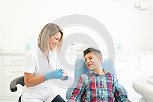 Dentist Explaining Patient At Clinic photo