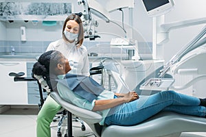 Dentist and female person, visit in dental clinic