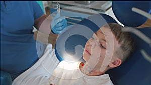 The dentist finishes examining the child