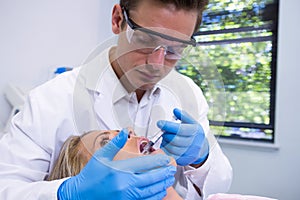 Dentist giving anesthetic to woman at medical clinic photo