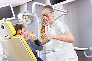 Dentist giving boy advice in dental surgery