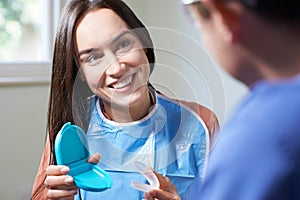 Dentist Giving Woman Advice On Cosmetic Teeth Whitening