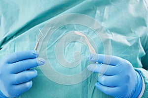 Dentist hands holding instruments for dental treatment