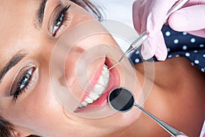 Dentist hands working on female teeth