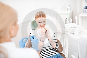 Dentist having patient afraid of the procedures.