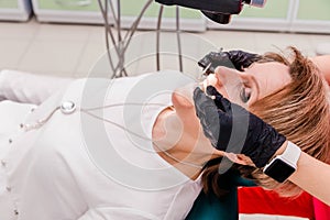 Dentist holding a dental tool of patients in the clinic.Woman lying on the dental chair for dentist checkup