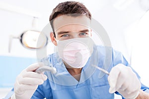 Dentist Holding Dental Tools