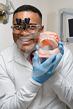 Dentist holding false teeth
