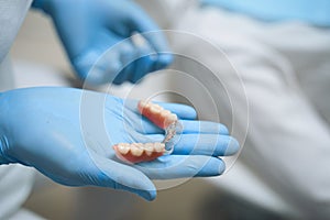 Dentist holding implants in hand stock photo