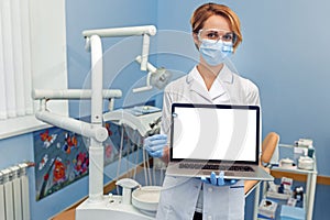 Dentist holding a laptop with empty place for your image