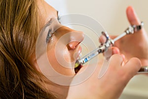 Dentist holding a syringe