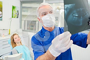 Dentist holding up x-ray