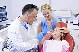 Dentist interacting with young patient