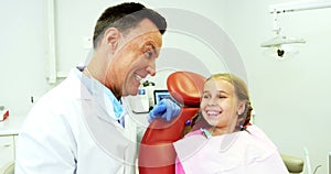 Dentist interacting with young patient