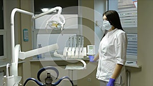 Dentist invites the patient to sit in the dental chair