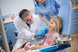 Dentist look teeth of young girl in dental ambulance