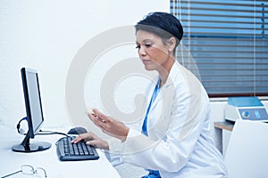 Dentist looking at mouth model by computer