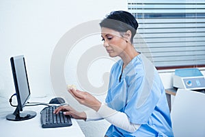 Dentist looking at mouth model by computer
