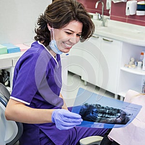 Dentist Looking At Patient X-ray Photography