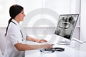 Dentist Looking At Teeth X-ray On Computer