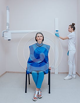 Dentist make x-ray image for young woman in dental clinic.