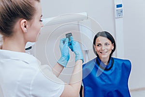 Dentist make x-ray image for young woman in dental clinic.