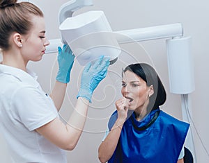 Dentist make x-ray image for young woman in dental clinic.