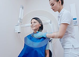 Dentist make x-ray image for young woman in dental clinic.