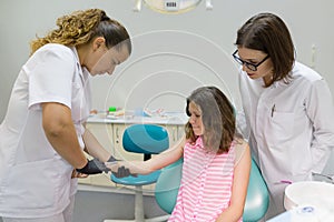 Dentist makes an injection in the hand, checks the reaction of the body to anesthetic preparations