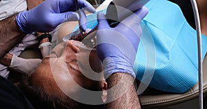 Dentist makes intraoral scan for patient before installing ceramic veneers and crowns