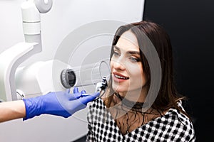 Dentist makes x-ray of the dental cavity for the patient in clinic