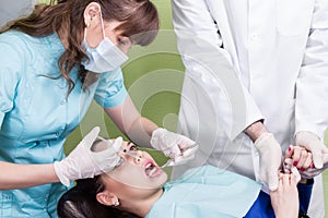 Dentist making anaesthetic injection to female