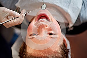 Dentist, mirror and child with teeth for cleaning and happy with healthcare at clinic or hospital. Dental, care and kid